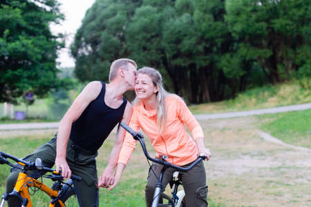 the Happy couple on bikes in the parkの写真素材