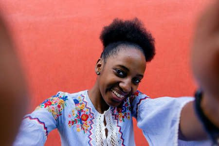 the Beautiful and happy African American takes a selfieの写真素材