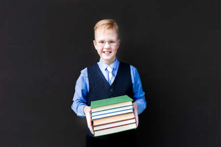 the boy in school uniform with books back to schoolの写真素材