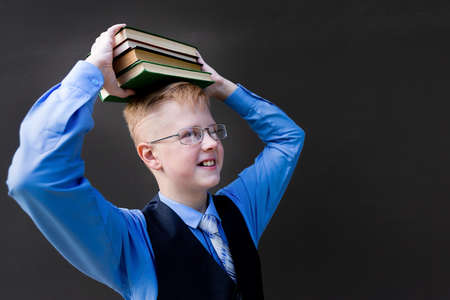the boy in school uniform with books back to schoolの写真素材