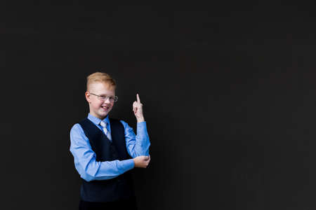 the Boy schoolboy stands by school board, back to schoolの写真素材