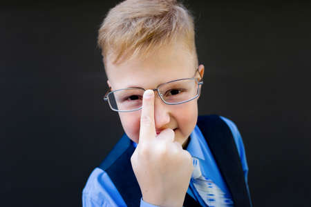 the Schoolboy in glasses, corrects glasses close-up