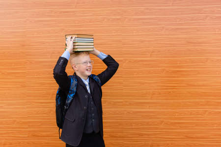 the schoolboy with a book on the street, back to school