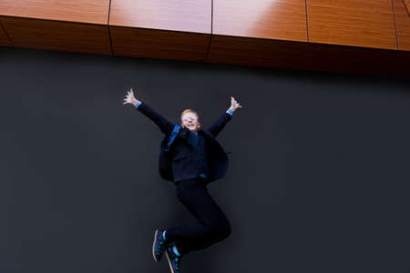 the schoolboy in a jump on a black backgroundの写真素材