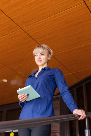 the blonde with a notebook on the street