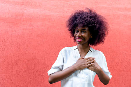 An African American woman makes a gesture of gratitudeの写真素材