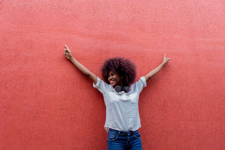 the Happy African American against the red wallの写真素材