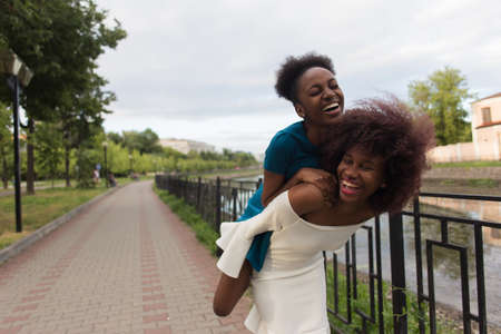 the Happy African American women cuddle, friendsの写真素材