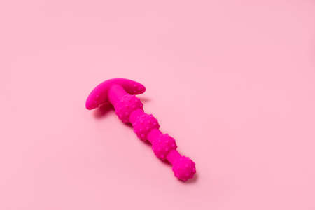 on a pink background sex product, a toy for adults