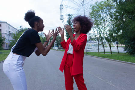 the two African American women laughing in the street