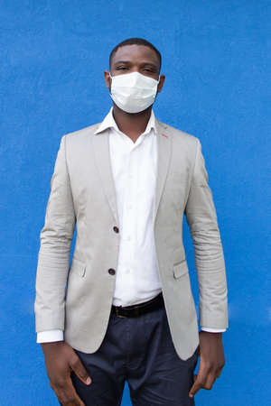 the African American in a protective mask on a blue backgroundの写真素材