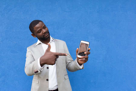 the African American shows his hand on phone screenの写真素材