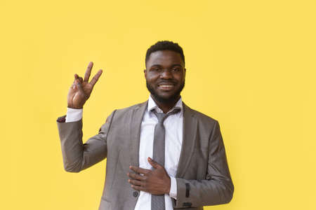 Hey, You. Positive African Guy Pointing Fingers At Camera Posing On Yellow Background. Studio Shotの写真素材