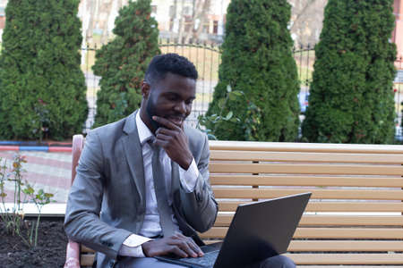 the African American on the street with laptop, freelancingの写真素材
