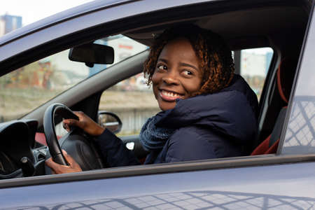 the beautiful and happy African American in the car