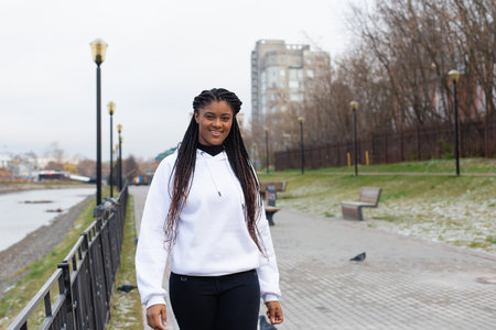 the happy African American woman in a full-length Parkの写真素材