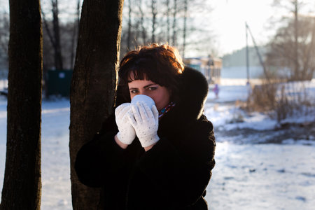 the happy woman in body in nature in winter with a Cup of teaの写真素材