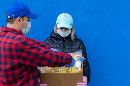 the volunteers with a charity box, on a blue backgroundの写真素材