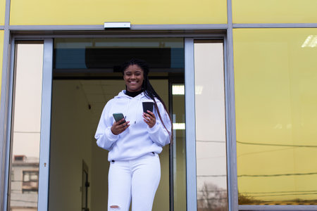 the happy African American woman coming out of the business center