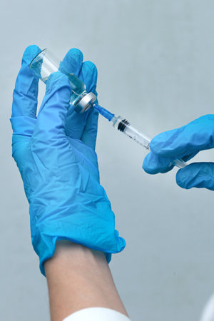 women's hands in medical gloves, vaccinationの写真素材