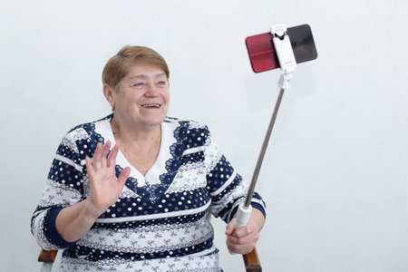 elderly woman writes a video for a blogの写真素材