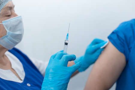 The nurse vaccinates the patient, vaccinationの写真素材