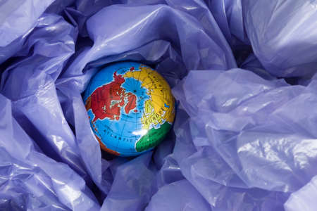 earth day, a globe in a garbage bagの写真素材