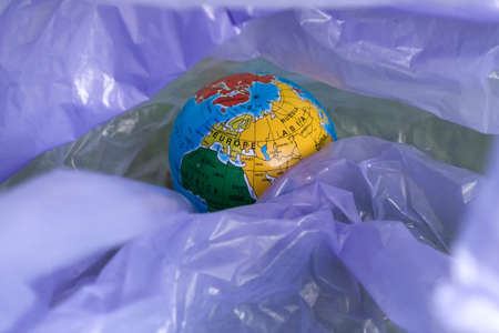 earth day, a globe in a garbage bagの写真素材