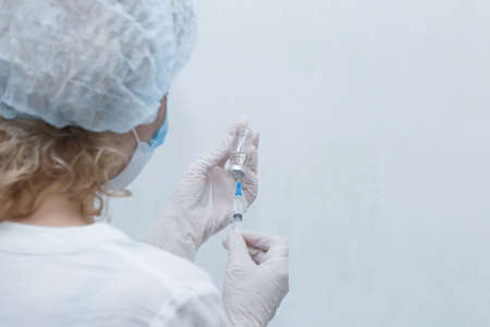 nurse with a vaccine on a white backgroundの写真素材