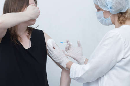 nurse makes a vaccine for a patientの写真素材