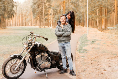 guy with a girl in the park on motorcycle