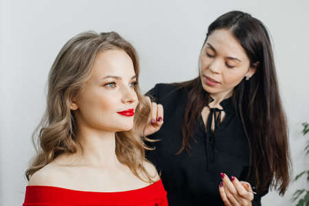 the master does a beautiful blonde makeup in a beauty salonの写真素材