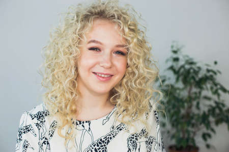 beautiful blonde admires her hair in a beauty salonの写真素材