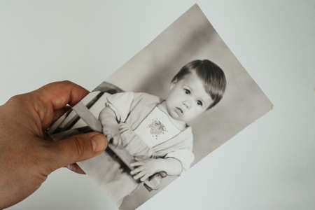 Ivanovo, Russia, May 26, 2021, a child's photo in the hand of an elderly woman, memories.のeditorial素材