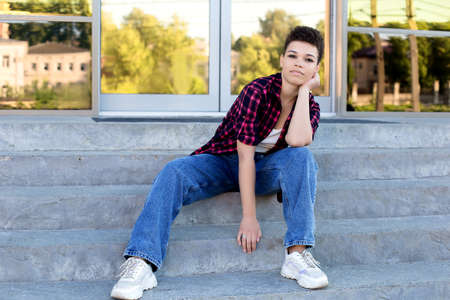 beautiful African American woman with short hair in the summer on the street.の写真素材