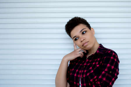 serious and beautiful african american woman with short hair, lifestyle.