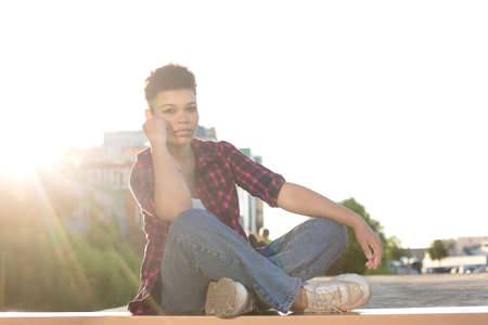 beautiful African American woman with short hair in the summer on the street.の写真素材