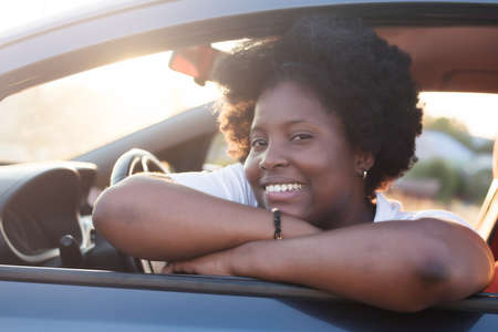 happy african american woman in a car, lifestyle.の写真素材