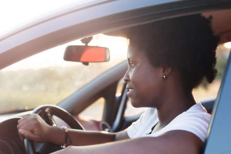 happy african american woman in a car, lifestyle.の写真素材