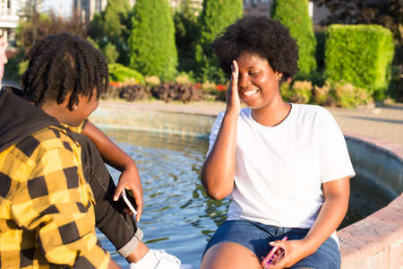 two happy African-American women are walking down the street in the summer.の写真素材