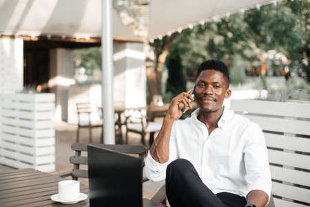 African-American businessman, works at a laptop in a cafe, freelancer.の写真素材