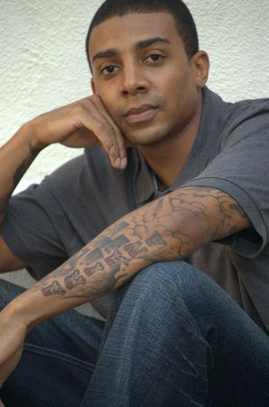 Portrait of a young black man with tattoosの写真素材
