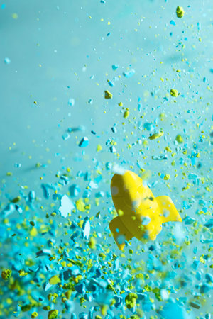 startup concept. A toy rocket flying on a background of colorful particles.の写真素材