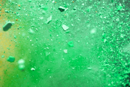 A burst of colorful yellow-green particles. Abstract splash background with selective focus.の写真素材