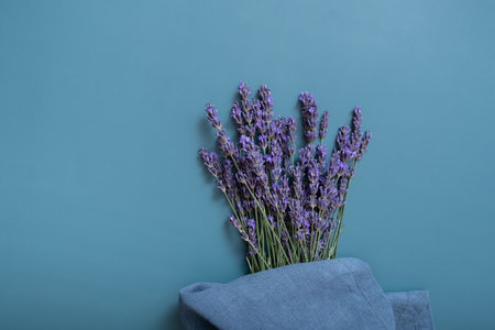 Lavender flowers on colored background with citchen towel top view. copyspace.の写真素材