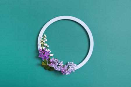 spring composition. Lily of the valley and lilac flowers with round frame copy space. Summer, spring floral concept.の写真素材