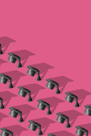 Pattern with black graduated cap on color background with copy space. education vertical background.の写真素材