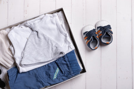 Children's clothes, shoes and toys in donation box. Second hand clothing recycling concept.の写真素材
