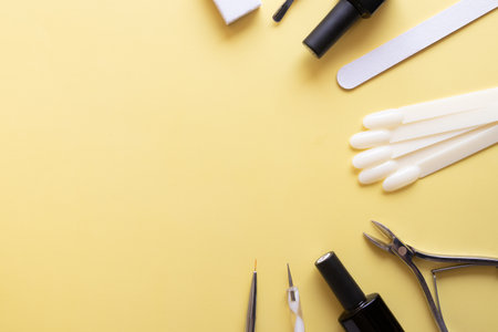 Manicure tools and tips on a colored background with copy space. Gel polish coating conceptの写真素材