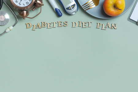 Diabetes Diet Plan text. Stethoscope, glucometer and plate with copy space on colored background.の写真素材
